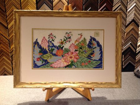 Water gilded gold frame with silk mat on vintage needlepoint