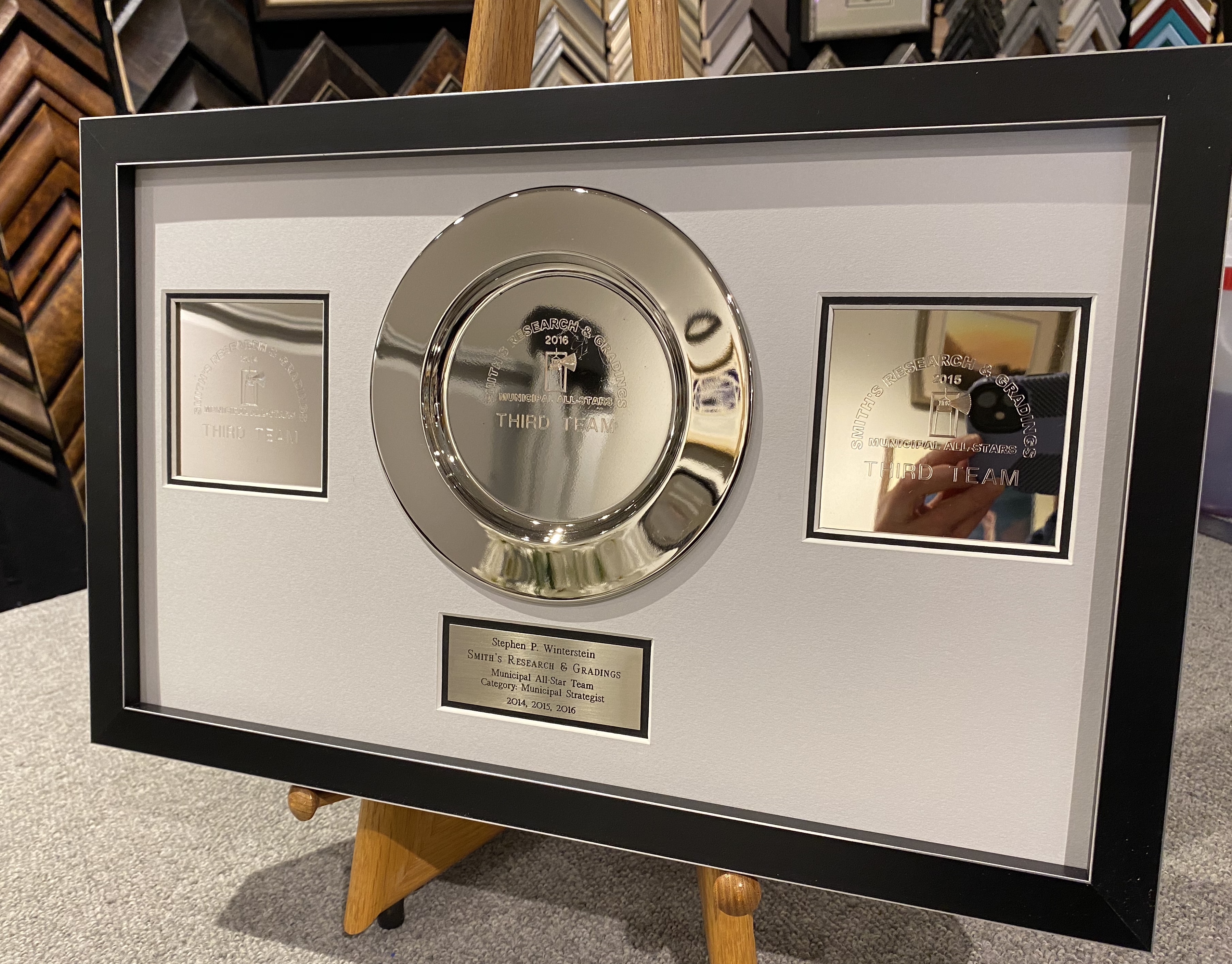 Engraved award plates in a shadowbox