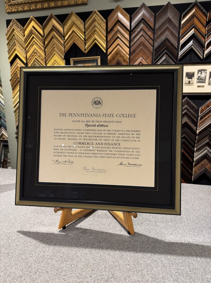 A vintage Penn State diploma from 1949 custom framed with a black mat, Museum Glass and a black and gold frame.